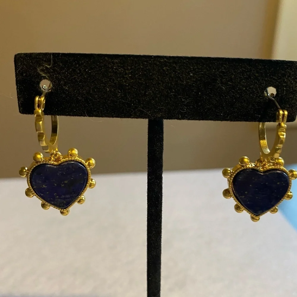 Tory Burch blue lapis heart drops hanging from huggie hoops.
